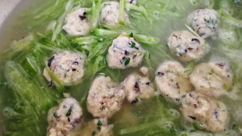 鸡肉丸子萝卜汤,放入萝卜丝,水开煮5分钟。放适量盐和香菜末。