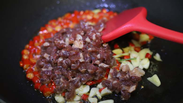 香辣小炒牛肉,然后下入牛肉丝，大火快速翻炒，饭店里这一步大概用时18秒，我做得也挺快，保持大火，如果再掂一下锅，牛肉的味道会更香。