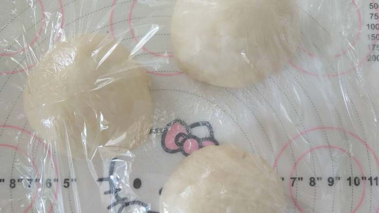 酸奶土司,7、取出分割成3份,滚圆盖保鲜膜松弛10分钟。