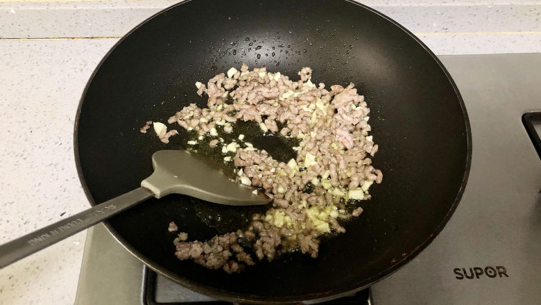 干煸四季豆,肉末炒香后倒入蒜末一起煸炒;