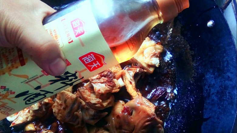 #冬季暖心菜# 粱山鸡,沿锅边倒入料酒。