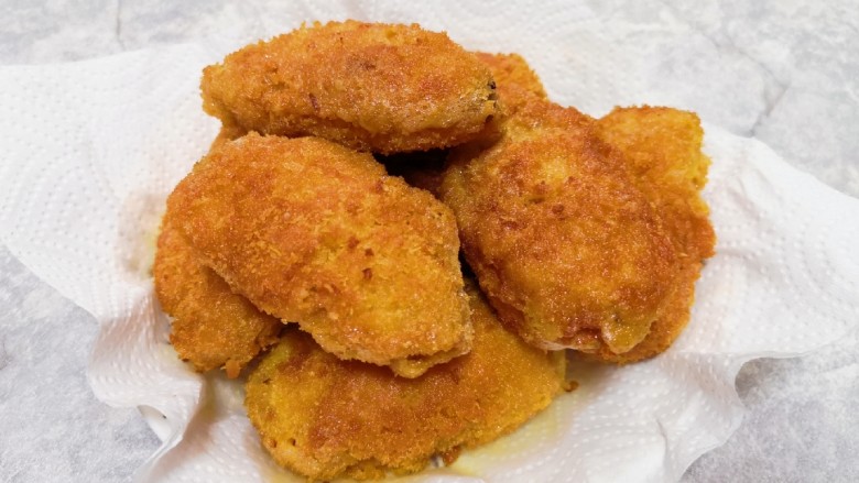 香酥炸鸡翅,盘子里铺上厨房用纸,放上炸好的鸡翅,吸一下多余的油分。