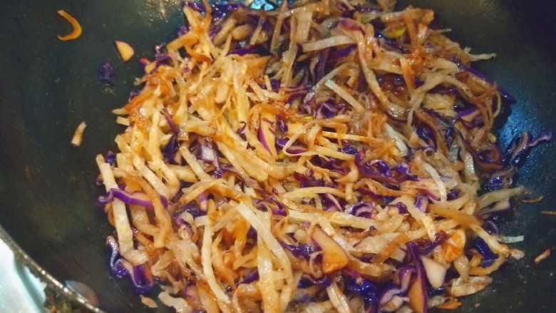 紫甘蓝炒饼丝,倒入饼丝,加入适量盐,炒均匀即可。