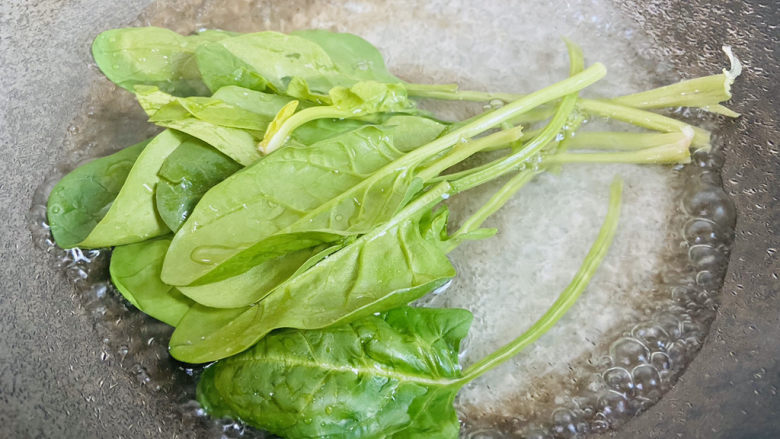 菠菜鸡蛋羹,锅中加入清水大火烧开加入少许盐和食用油放入菠菜焯烫20秒捞起