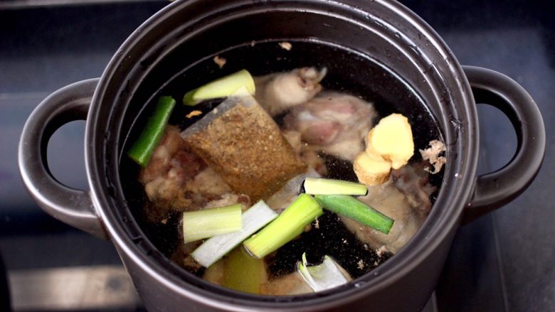 白果炖鸡,砂锅里一次性倒入足够的炖汤的清水,放入葱段和姜片,加入炖鸡汤调料包。