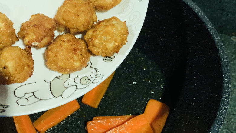 糖醋肉丸,把炸好的肉丸倒入胡萝卜中;