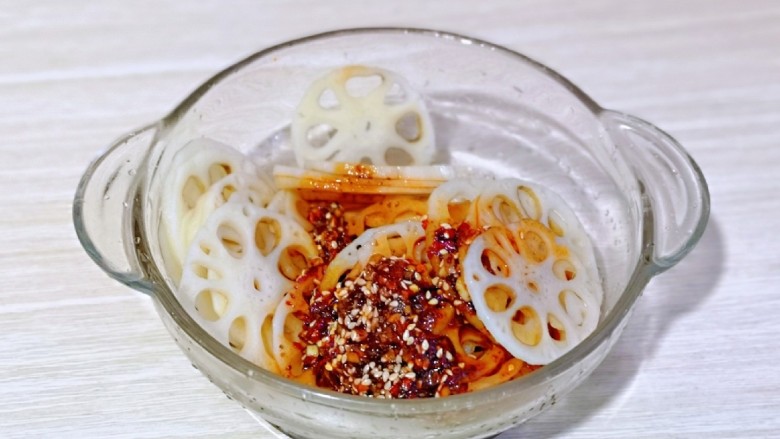 醋溜藕片,冷水浸泡后捞出淋干水分,放入器具中,将调好的调味料淋在藕片上。