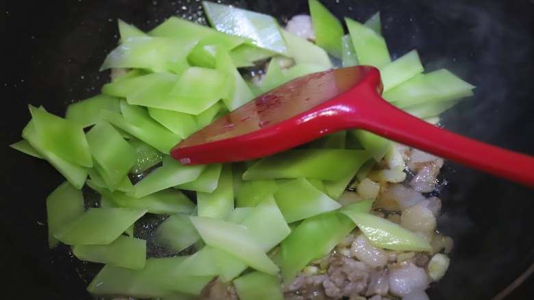 莴笋炒肉片,待肉片变色以后,加入切好的莴笋片,快速翻炒,让莴笋受热均匀。