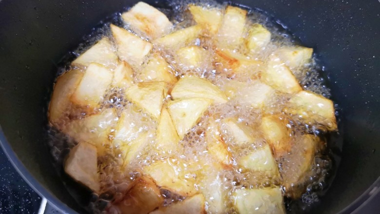 麻辣干锅鸡,土豆块用厨房用纸吸一下表面的水分,炸锅内倒入多一些食用油烧热,下入土豆块炸至金黄色捞出备用。