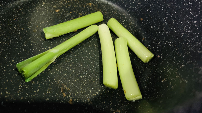 蒜苗炒猪肝,直接将蒜苗倒入锅内炒香;