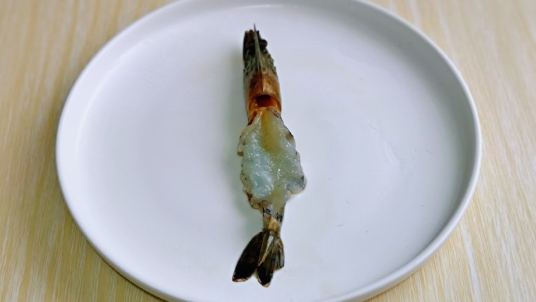 蒜蓉蒸大虾,把虾身上的皮去掉,头尾留下,如图。