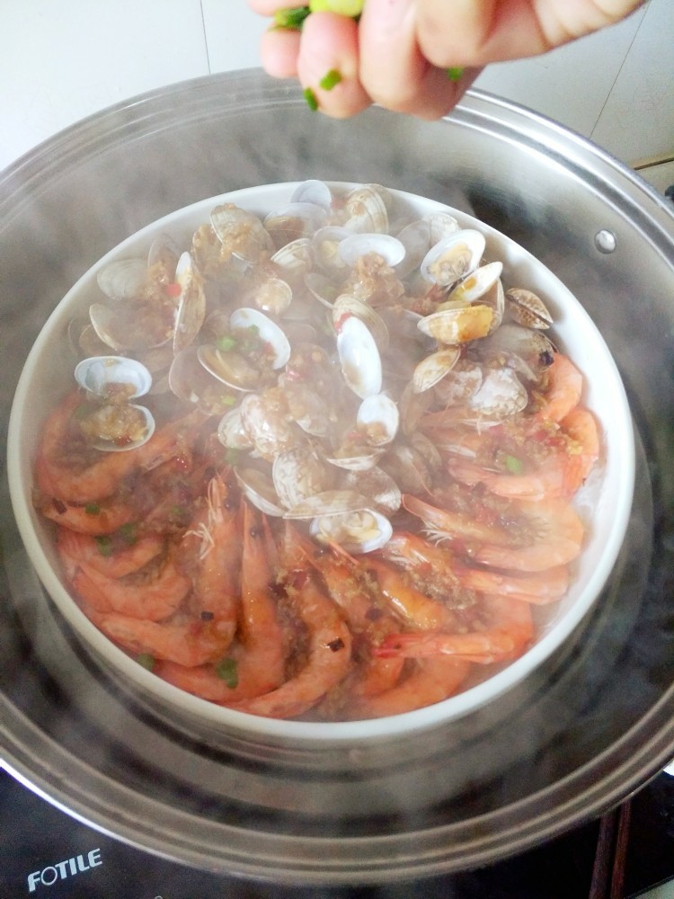 蒜蓉蒸大虾,淋完酱料,撒上葱花,
接着盖好锅盖,再大火蒸一分钟