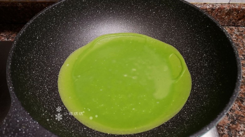 菠菜蛋卷,锅烧热倒入适量菠菜鸡蛋糊,小火慢煎。