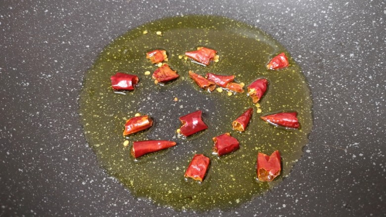 蒜苔炒牛肉卷,炒锅内倒适量的食用油烧热,将<a style='color:red;display:inline-block;' href='/shicai/ 86464'>干红辣椒</a>掰开下入爆香。