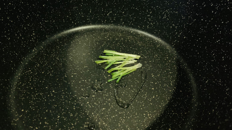 生滚牛肉粥,锅里加一点油,放入葱白炒香;