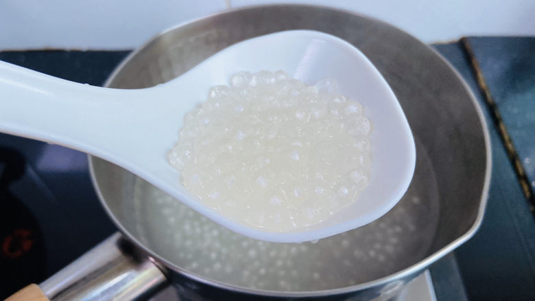芒果西米捞,盖上盖子煮十分钟关火焖五分钟再煮三至五分钟,煮到西米没有白心为止(期间搅拌数次防止粘锅底)