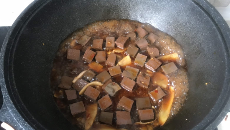 韭菜炒鸭血,将血块铺开,均匀地浸在汤里,烧两分钟;