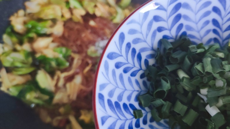 卷心菜炒粉丝,加入小葱,翻炒均匀即可