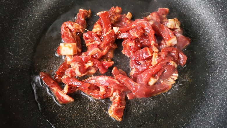 牛肉丝炒芹菜,锅中适量油烧热，下腌制好的牛肉。