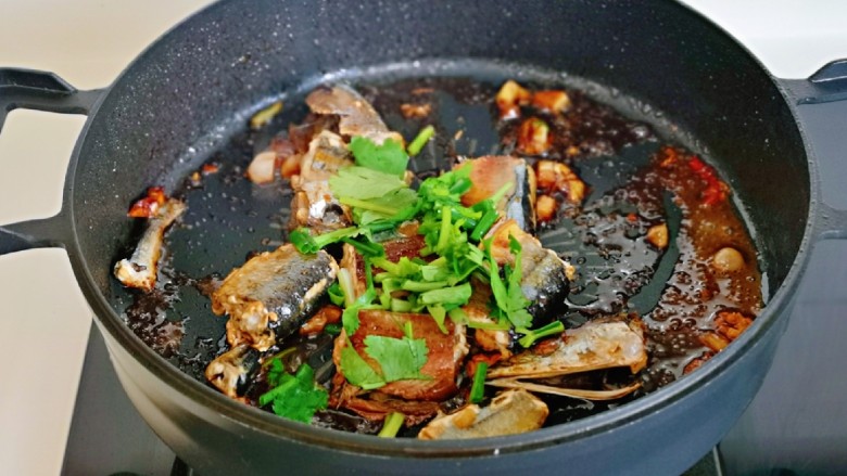 红烧秋刀鱼,收至浓稠,关火,撒上葱花及<a style='color:red;display:inline-block;' href='/shicai/ 131'>香菜</a>,借助油温烫熟即可。