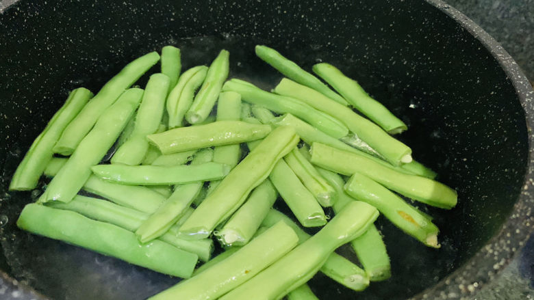 橄榄菜炒四季豆,加四季豆,焯水,捞出;
