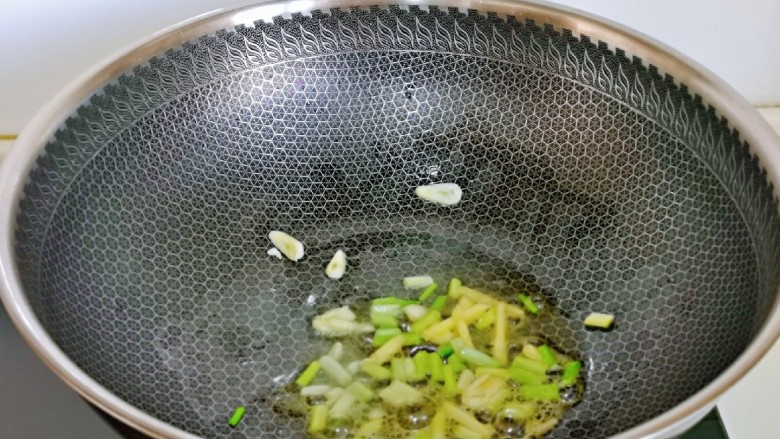 山药炒肉片,起油锅,加入切好的葱姜蒜炒香。