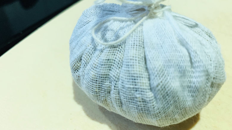胡椒猪肚鸡,把捣碎的胡椒,用纱布包好,棉线扎紧;
