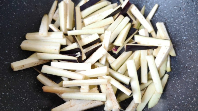 豇豆烧茄子,炒锅内继续倒油烧热,下入茄条。
