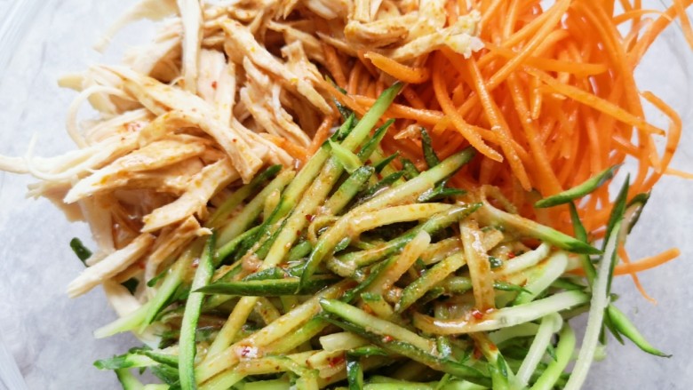 手撕鸡胸肉,将调好的酱汁浇在鸡胸肉和菜丝上面。