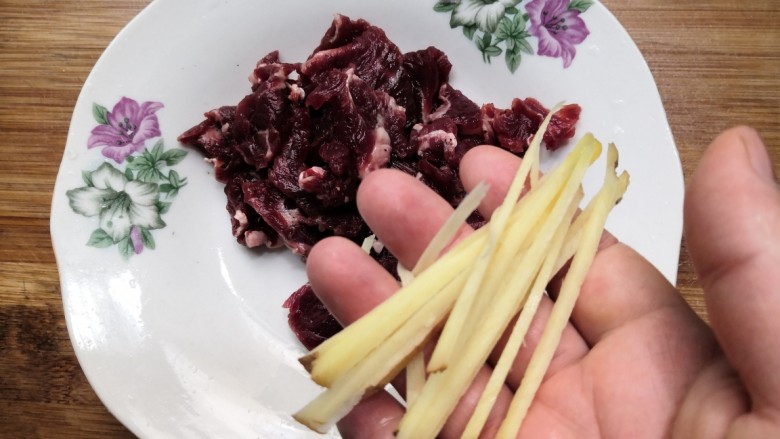 西兰花炒牛肉,把牛肉和姜丝，放入盘中