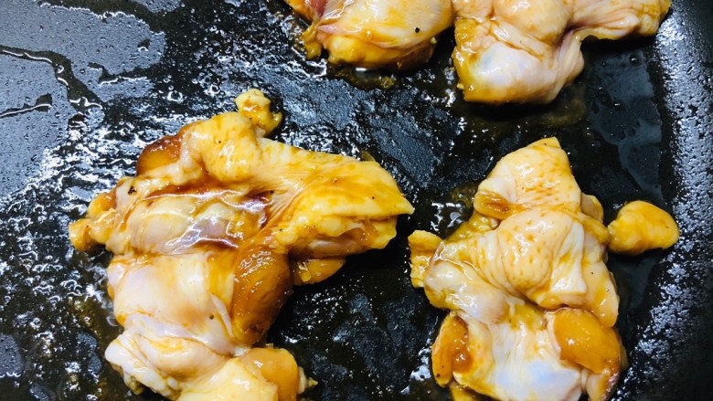 香煎无骨照烧鸡腿,调小火烹饪,用筷子把鸡腿一个一个地夹进不粘锅里慢慢煎。