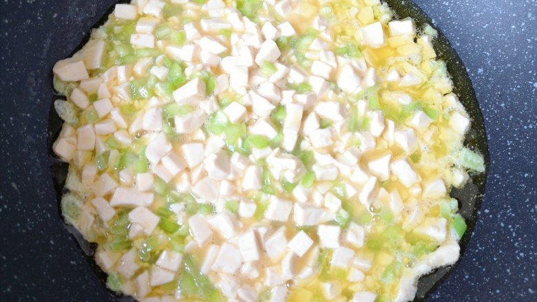 豆腐炒鸡蛋,炒锅内倒适量的食用油烧热，倒入豆腐蛋液。