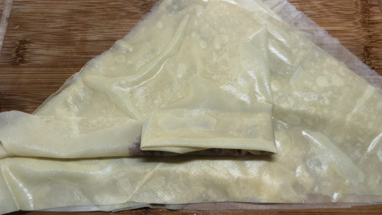 千张包肉,把右侧多余千张折到中间,长度就和肉糜一样,多的部分折进去