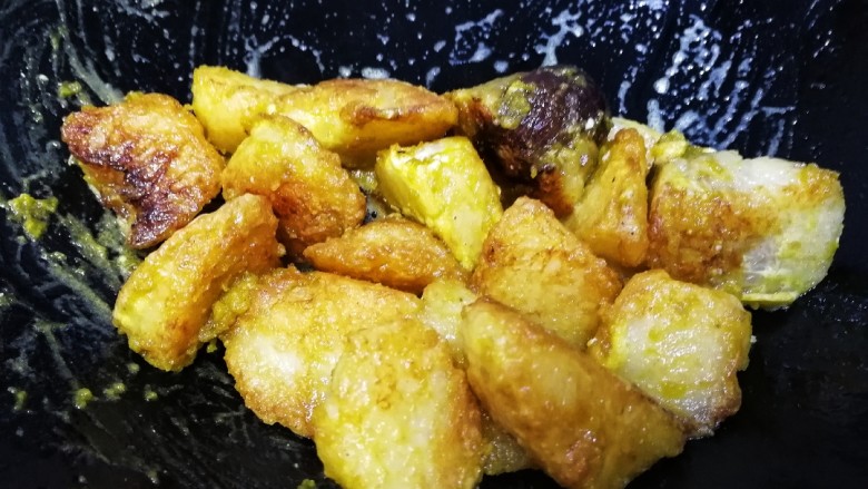 金沙粽子,晃动炒锅,小火让咸蛋黄均匀的包裹上粽块儿。