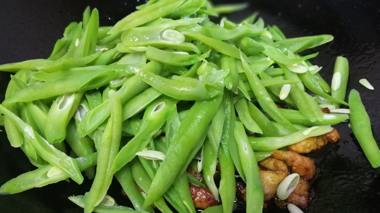 四季豆炒肉,放入四季豆,文火翻炒。