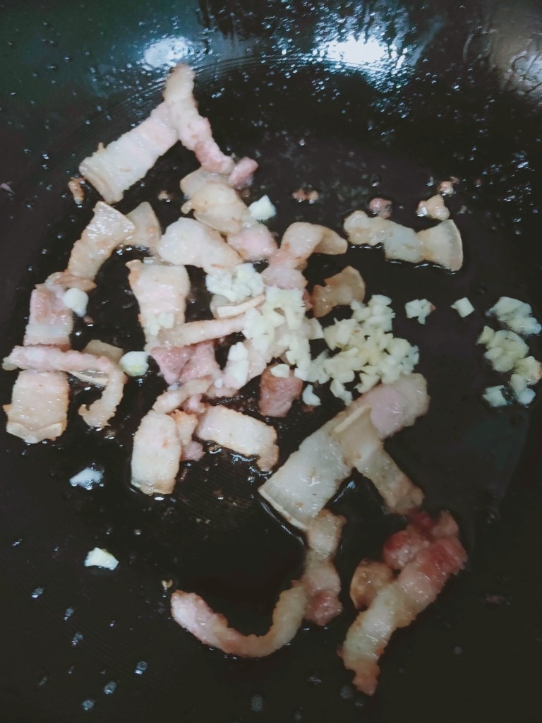 四季豆炒肉,倒出油后,加入蒜蓉炒香