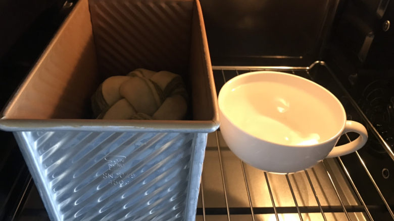 一次发酵的抹茶大理石纹吐司,烤箱里放一碗80度左右的热水,打开发酵功能,醒发约一个小时