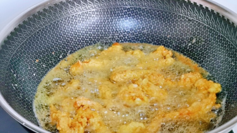 椒盐里脊,起油锅,待油温升高时用筷子夹入裹好淀粉的肉条,动作尽量快点哈,中小火炸制金黄捞出控油。