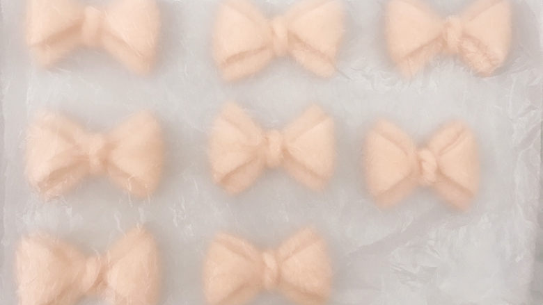 蝴蝶结面包,放在烤盘上,盖上保鲜膜进行二次发酵。