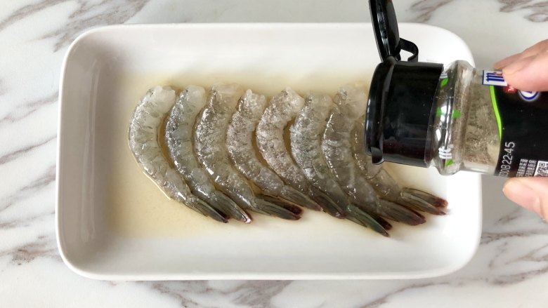 不加一滴油的凤尾虾球,整只鲜虾包成团,外脆里软, 虾肉鲜美,虾仁处理好后,加入<a style='color:red;display:inline-block;' href='/shicai/ 718'>料酒</a>、盐、胡椒粉抓匀,腌制15分钟。