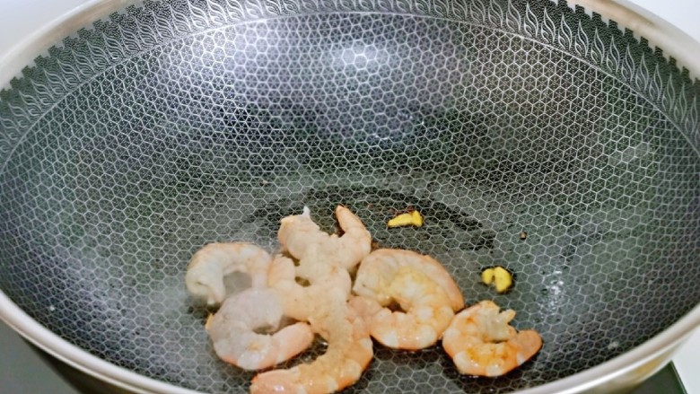 青椒炒豆腐,起油锅,加入腌制好的虾仁煸炒至变色,盛出备用。