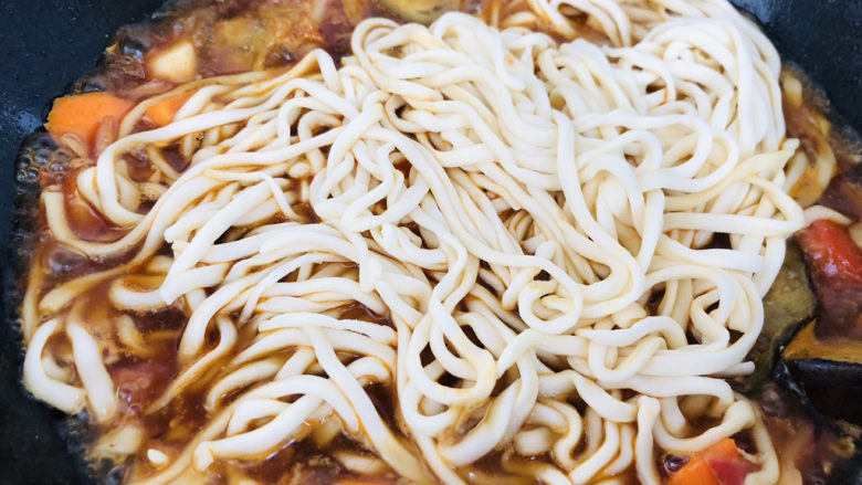 茄子焖面,把<a style='color:red;display:inline-block;' href='/shicai/ 526'>面条</a>铺在上面,用筷子稍微整理均匀,盖上盖子大火上汽后转小火焖10分钟即可。