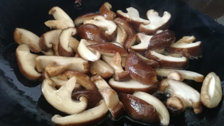 香菇炒青菜,放入香菇片,急火翻炒出香味。