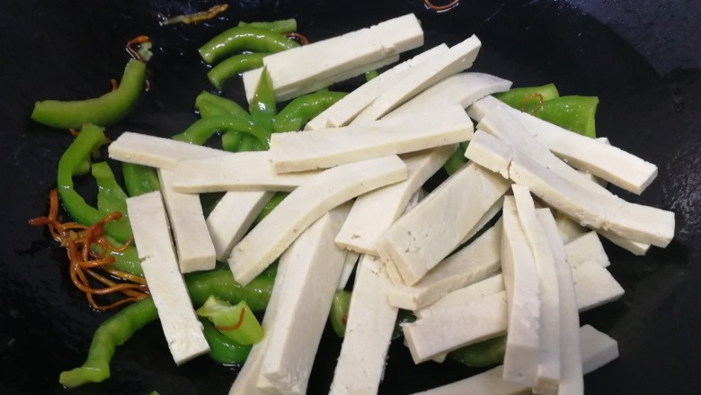 青椒炒香干,放入香干,文火翻炒均匀。