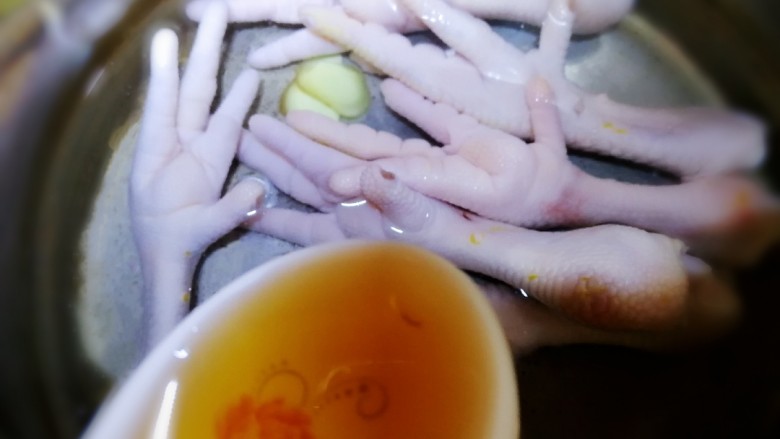 无骨鸡爪,冷水下锅,放入姜片,<a style='color:red;display:inline-block;' href='/shicai/ 718'>料酒</a>,水开盖上盖子煮10分钟。