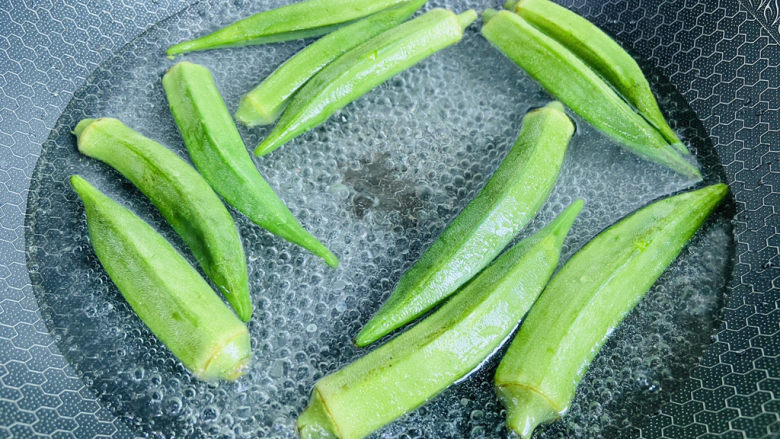 秋葵炒虾仁,锅中加入清水大火烧开,加入适量盐和食用油,放入秋葵焯烫三分钟