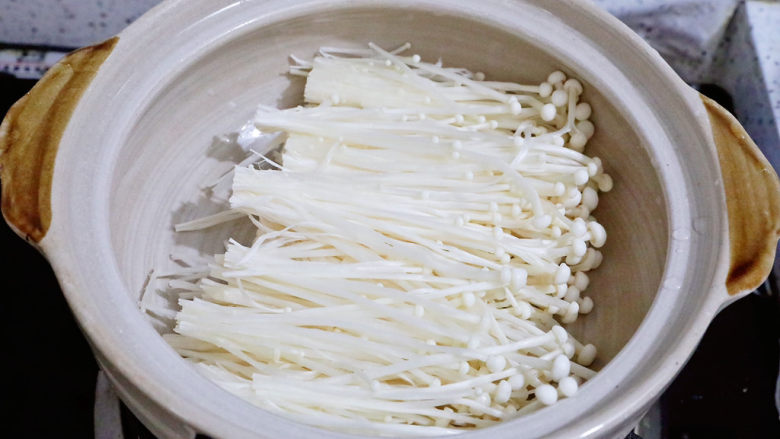 豆腐虾仁粉丝煲,砂锅刷一层食用油,放入金针菇