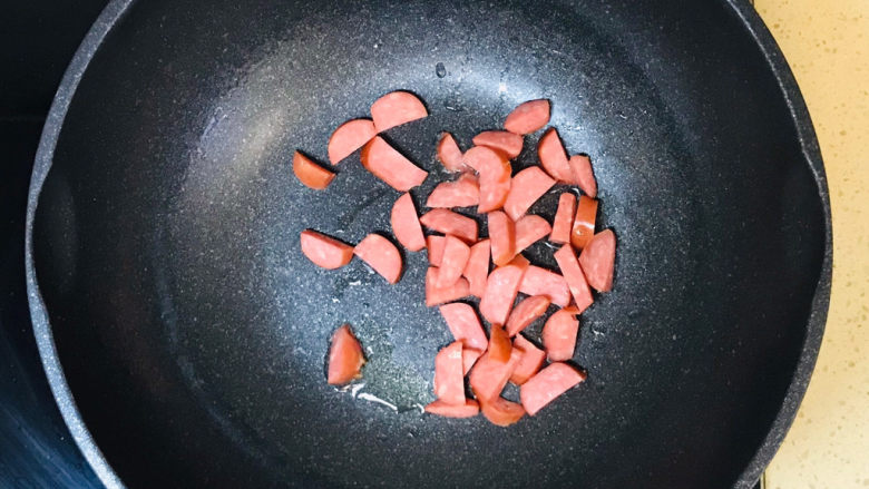 苦瓜炒腊肉,起油锅,油烧热后,投入香肠翻炒