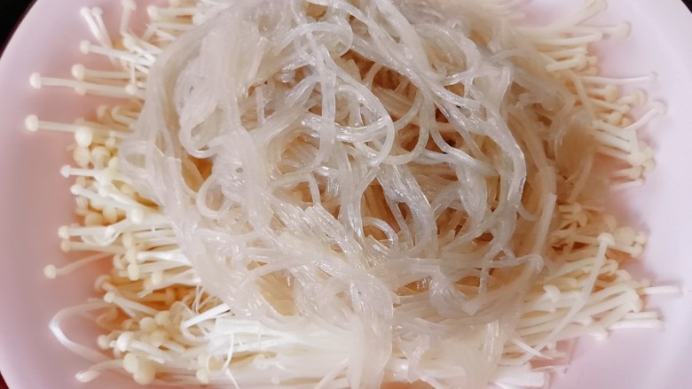 蒜蓉粉丝蒸金针菇,将金针菇摆在盘底 ,上面放粉丝