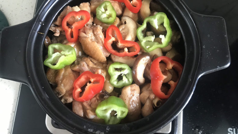 香菇滑鸡煲仔饭,摆入青红椒,开小火焖6分钟